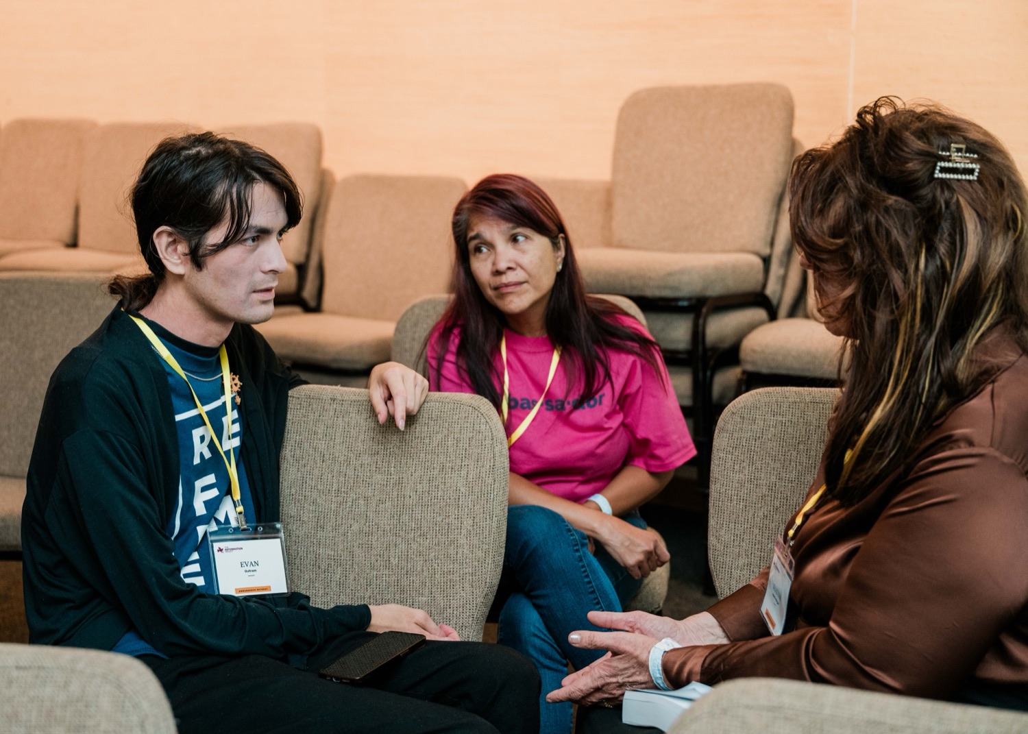 Three Reformation Project ambassadors in close conversation at the 2026 Ambassador Retreat