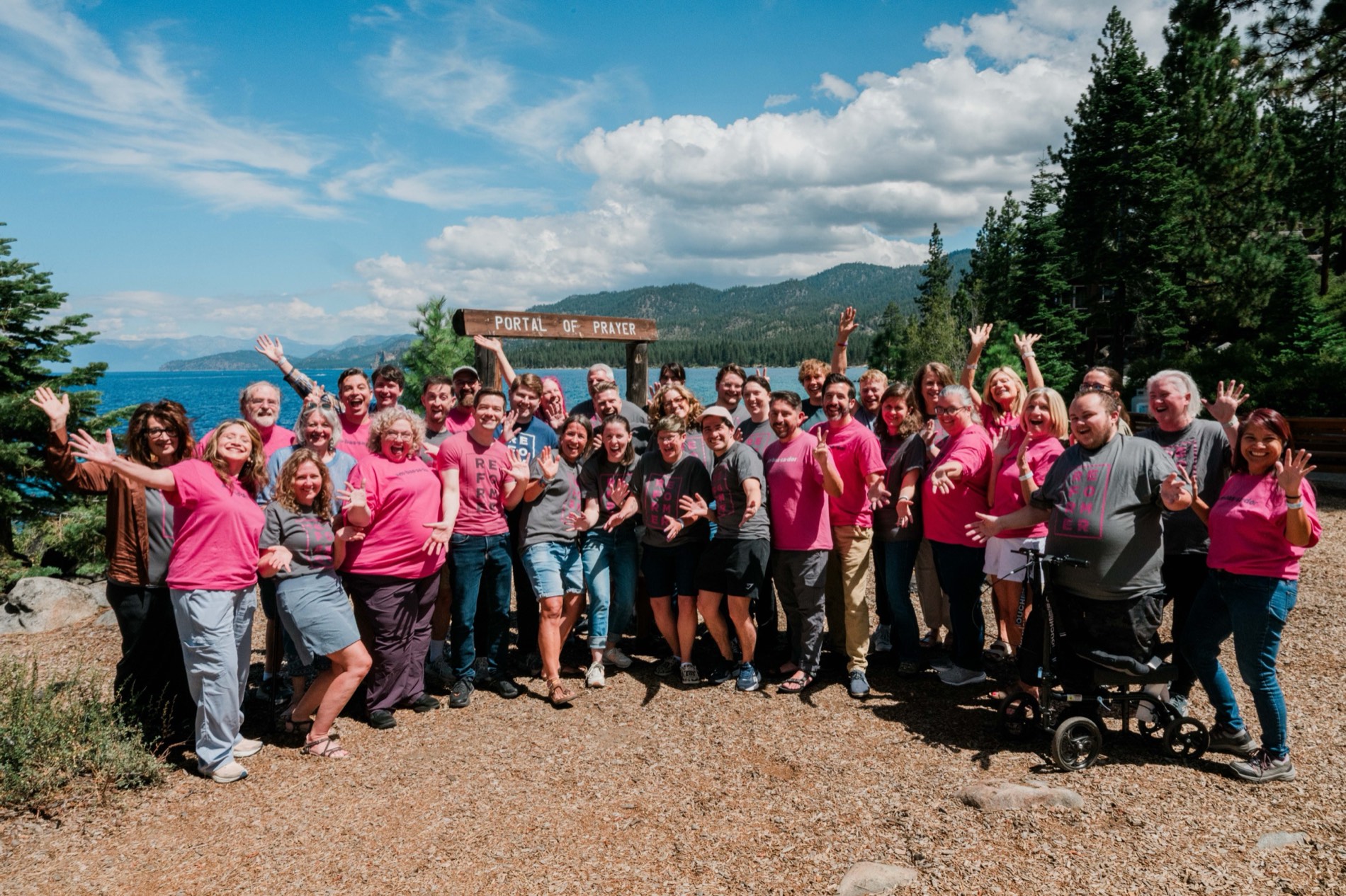 Reformation Project ambassadors waving together beside Lake Tahoe