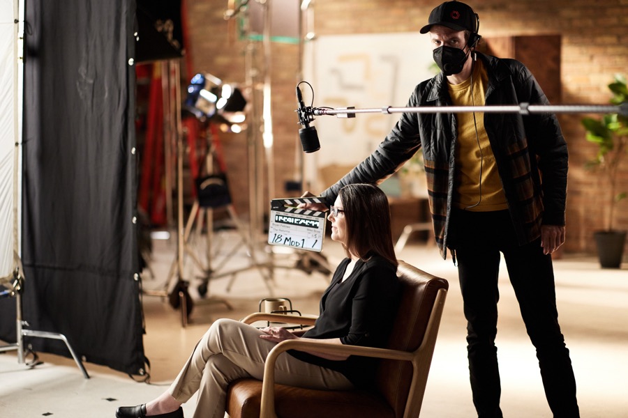 A crew member slating a take with Karen Keen